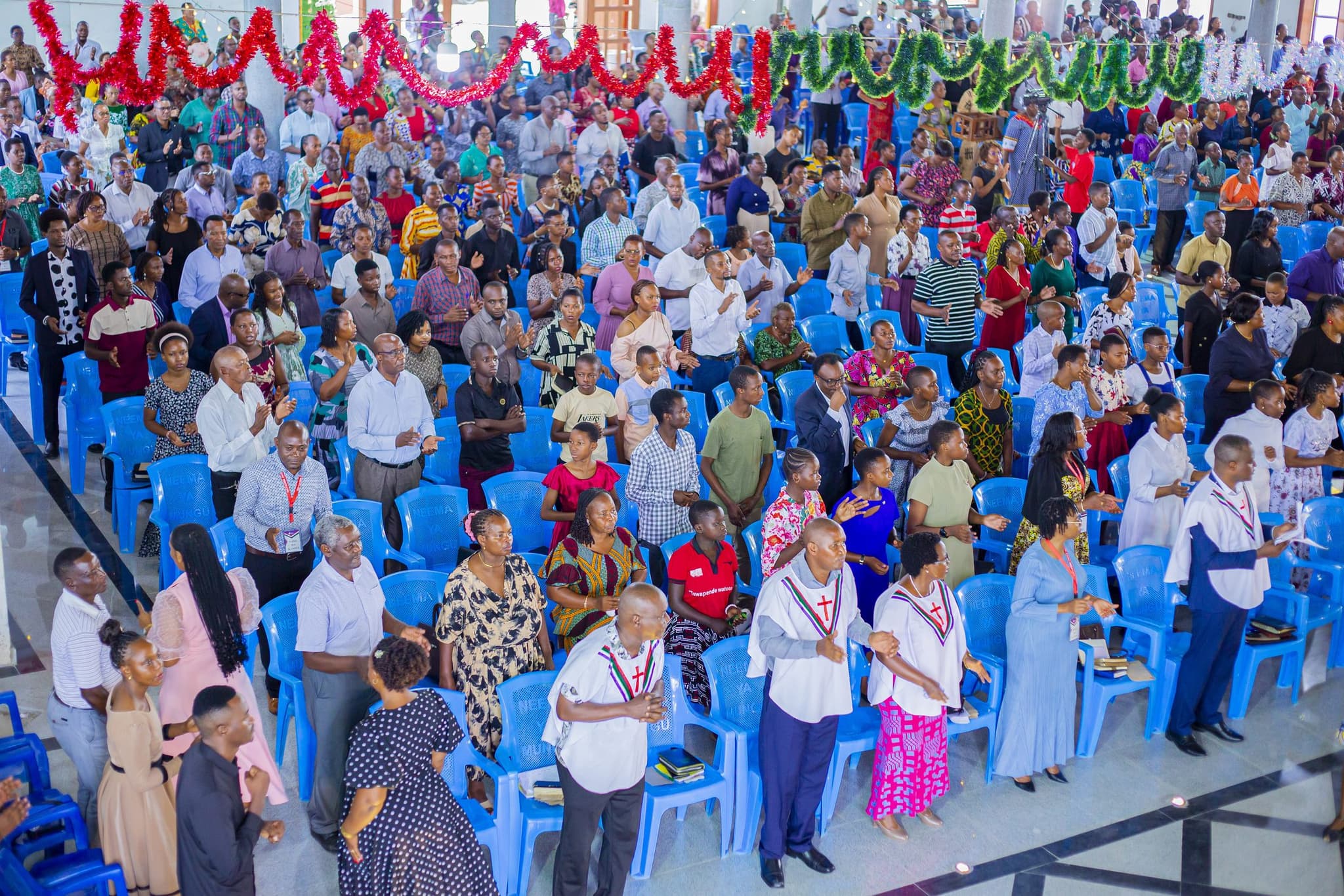 The congregation of Mbezi Luis standing together in worship